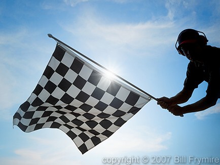 man waving checkered flag - model released